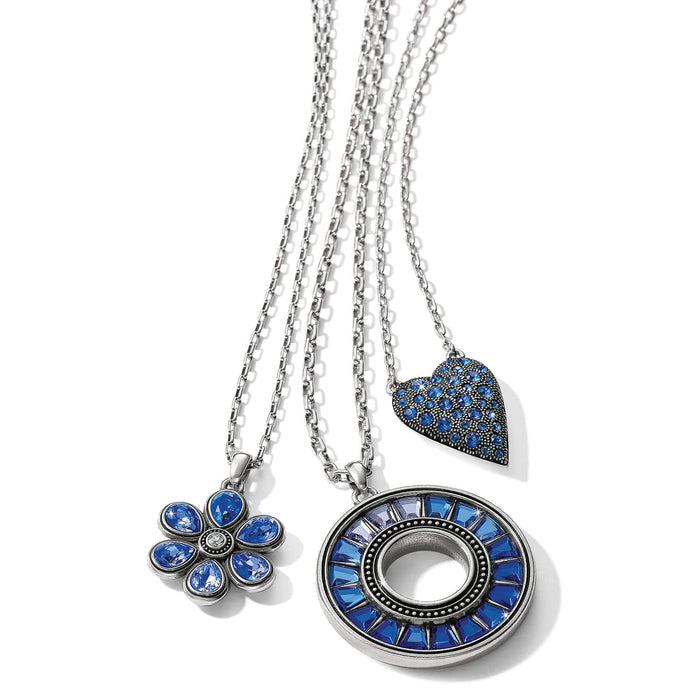 Brighton silver-plated pendant necklaces with blue crystal flower, heart, and circular medallion designs on a white background