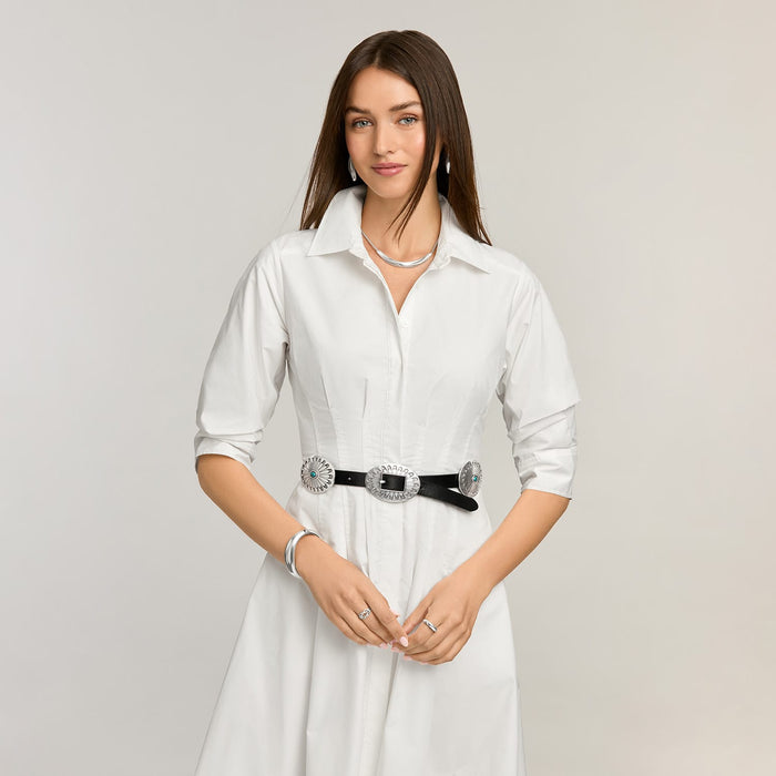 Model wearing a Brighton black leather belt with silver-tone concho medallions and turquoise stone accents