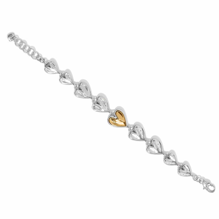 Brighton bracelet with linked silver-tone hearts and a central gold-tone heart, featuring adjustable chain, on a white background