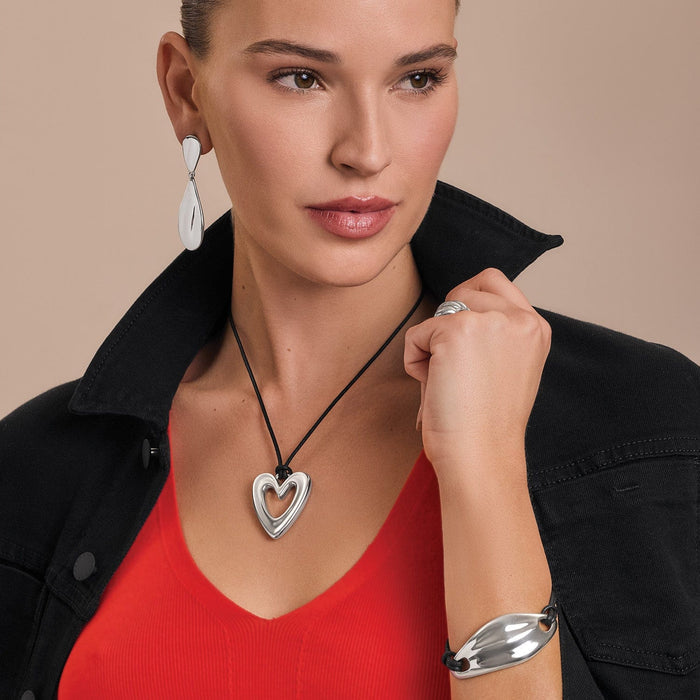 Model wearing a Brighton silver-plated heart pendant necklace on black cord with coordinating Brighton accessories