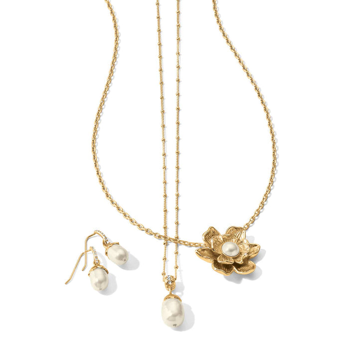 Brighton gold-tone necklaces and pearl drop earrings with crystal accents and flower pendant on a white background