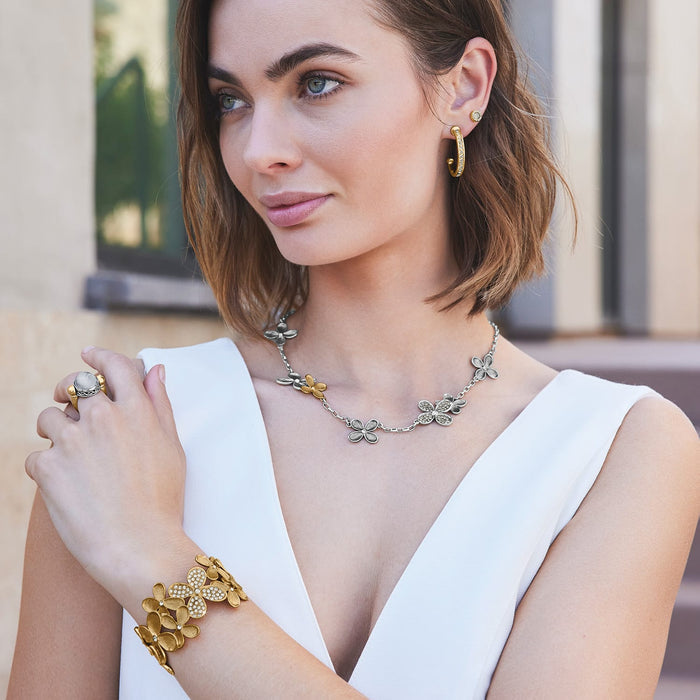 Model wearing a Brighton two-tone floral necklace with coordinating Brighton earrings, bracelet, and ring accessories