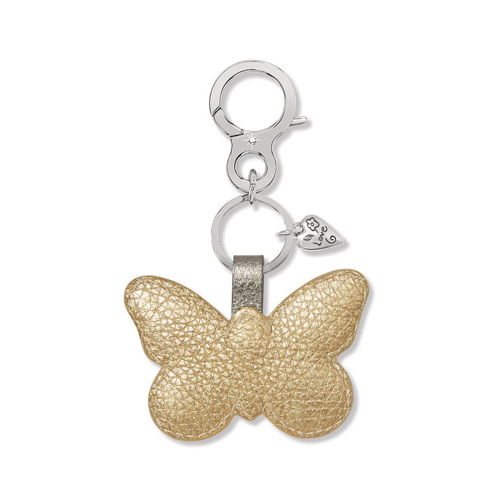 Brighton butterfly bag charm in gold leather with silver-tone clasp and engraved love heart accent on a white background