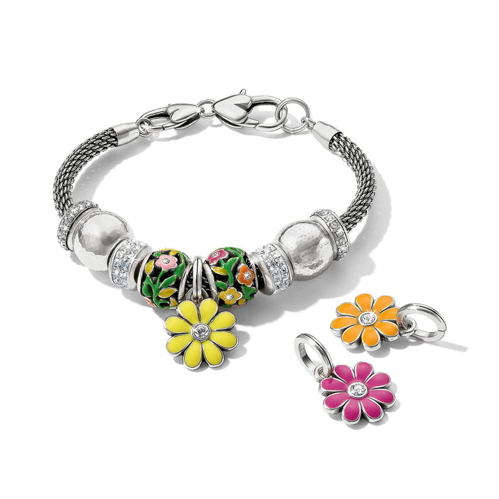 Brighton silver-plated charm bracelet with floral enamel beads, crystal accents, and yellow, orange, and pink daisy charms on a white background