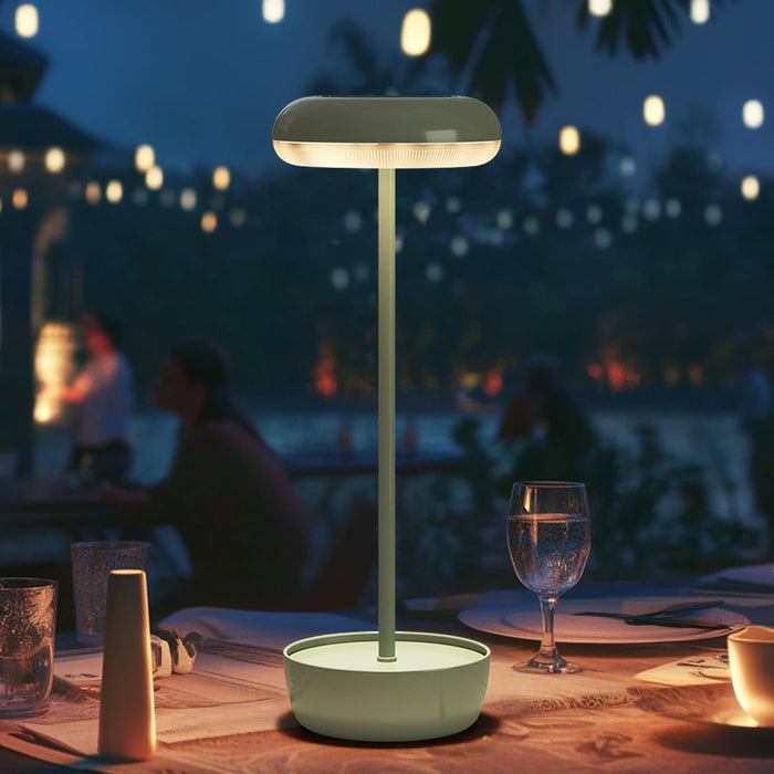 Table lamp on a table with a blurred outdoor night scene in the background