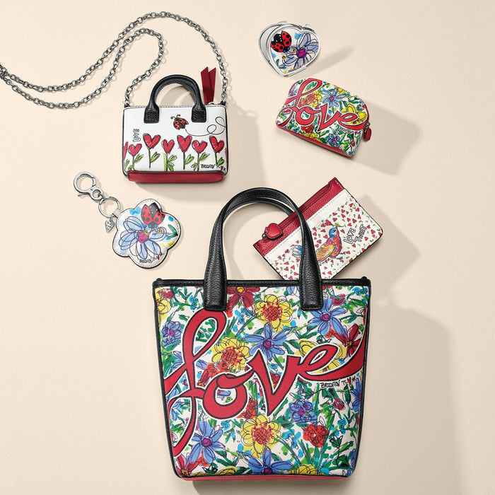Brighton leather handbag with floral love print, styled with a coordinating mini bag and other accessories