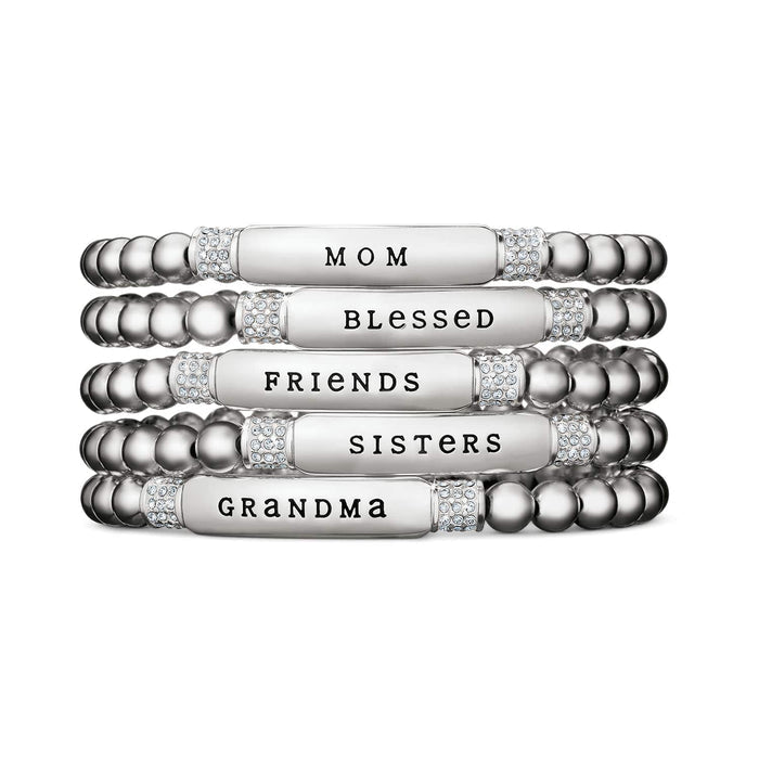 Brighton stretch bracelets stacked with silver-plated bars reading Mom, Blessed, Friends, Sisters, Grandma with crystal accents on a white background
