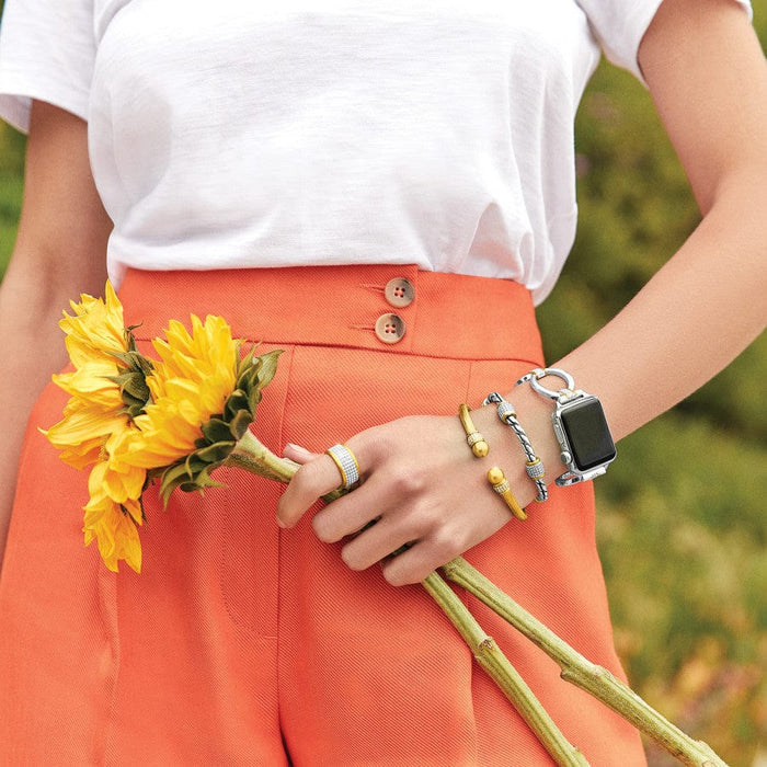 Meridian Tempo Apple Watch Band on woman's wrist while holding sunflowers
