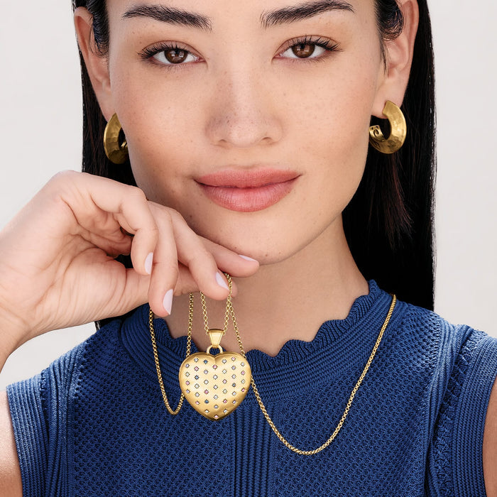 Model wearing a Brighton gold-plated heart pendant necklace with multicolored crystal accents and coordinating Brighton accessories