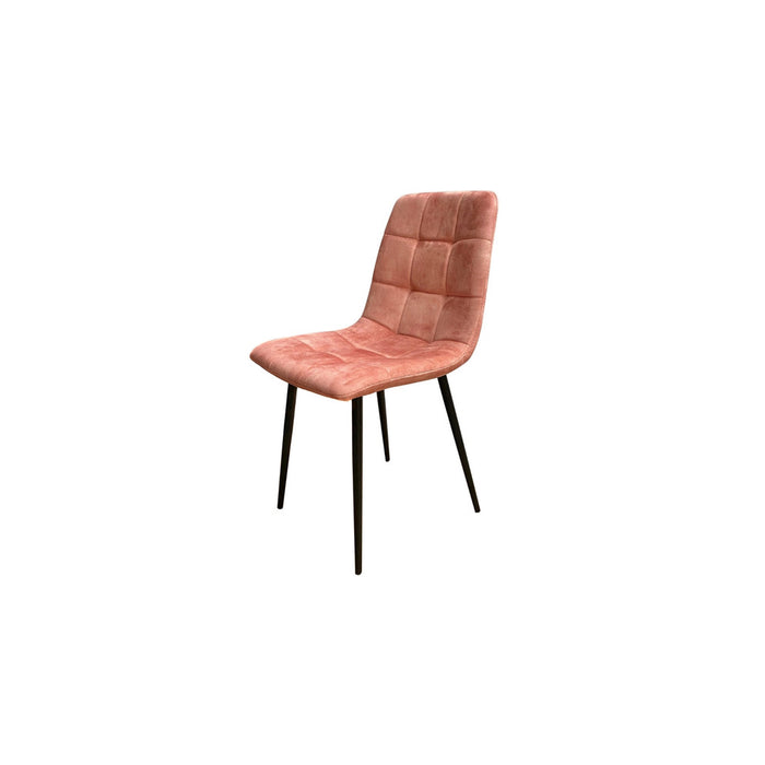 Peach velvet upholstered dining chair with black legs on a white background