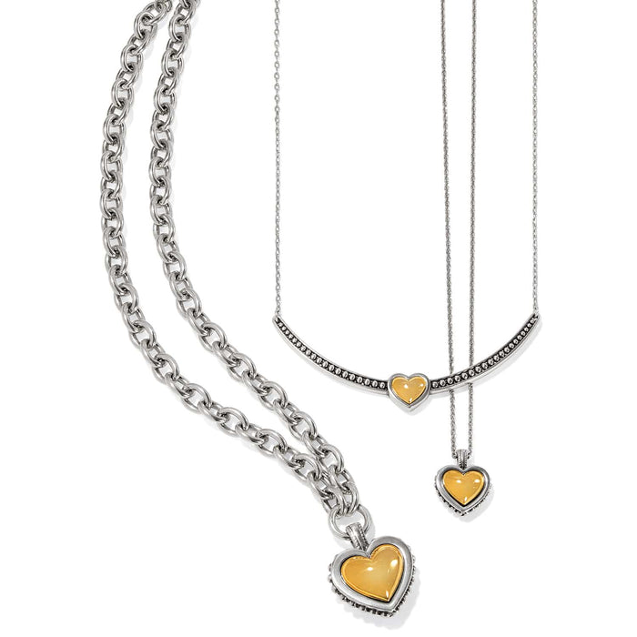 Brighton two-tone necklaces with silver chains and gold heart pendants in varying sizes on a white background