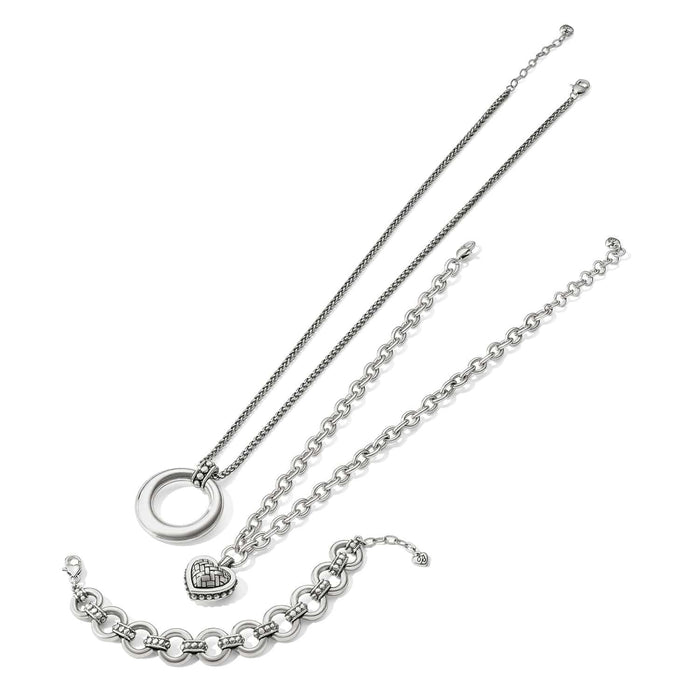 Brighton jewelry set styled with silver-plated pendant necklace and two link bracelets on a white background