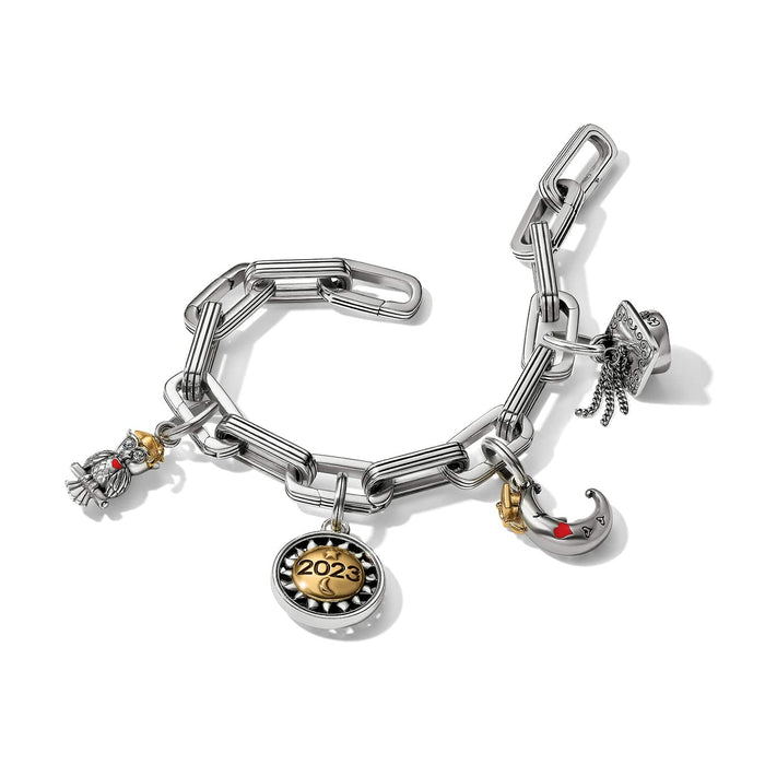 Brighton charm bracelet with silver-tone links, two-tone 2023 medallion, owl, moon, and graduation cap charms on a white background