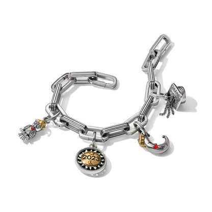 Brighton charm bracelet with silver-tone links, two-tone 2023 medallion, owl, moon, and graduation cap charms on a white background