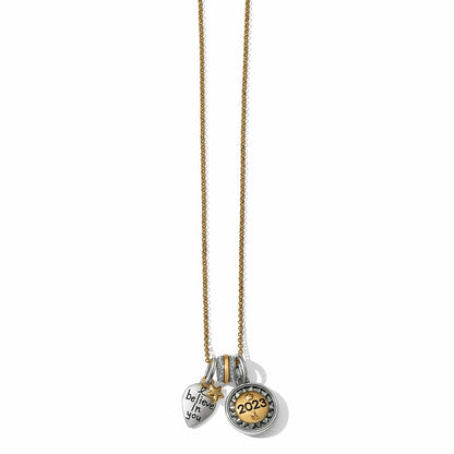 Brighton charm necklace with two-tone heart, crystal spacer, and 2023 medallion pendants on a white background