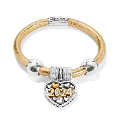 Brighton charm bracelet in gold leather with silver beads and two-tone 2024 heart charm on a white background