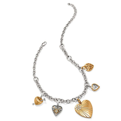 Brighton charm bracelet with two-tone heart charms, crystal accents, and silver-tone chain on a white background