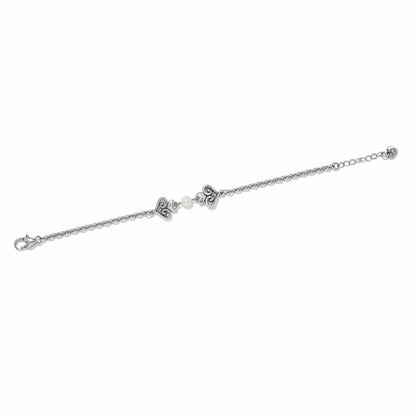 Brighton bracelet with silver-plated heart stations, glass pearl accent, and lobster clasp on a white background