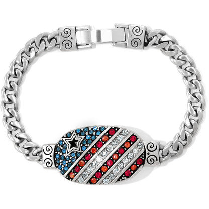 Brighton bracelet with silver-plated curb chain and oval American flag medallion in blue, red, and clear crystals on a white background