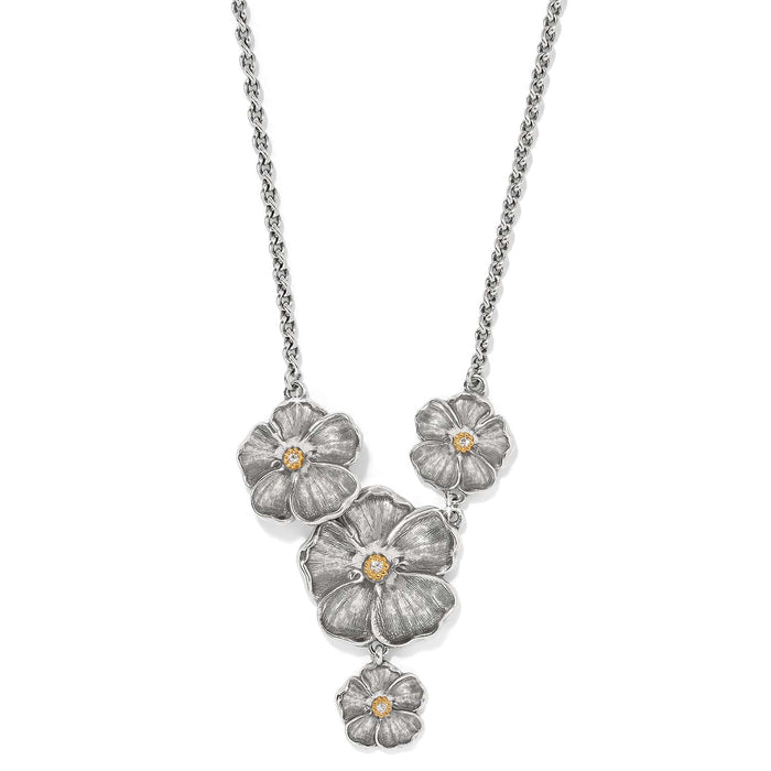 Brighton necklace with silver-tone flower pendants, gold-tone centers, and crystal accents on a white background