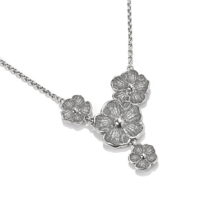 Brighton floral pendant necklace with clustered silver-tone flower blossoms and delicate chain on a white background