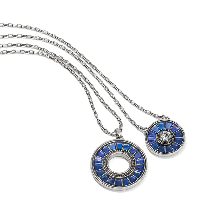 Brighton pendant necklaces with blue crystals and silver-plated circular medallions on double chains on a white background