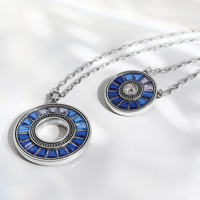 Brighton silver-plated pendant necklaces with blue and purple crystal medallions in circular openwork designs on a white background