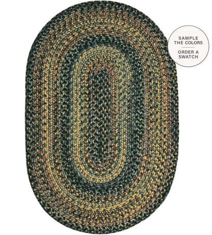 An oval braided area rug with concentric bands of dark green, black, tan, and brown, shown on a white background with a circular callout in the top right.