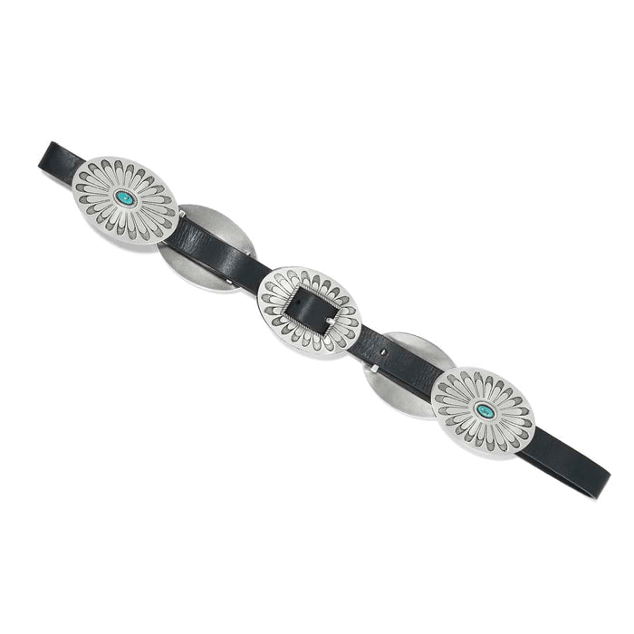 Brighton black leather belt with oversized oval silver-tone concho medallions and turquoise stone accents on a white background