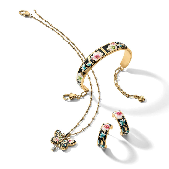 Brighton gold-plated jewelry set styled with butterfly pendant necklace, floral enamel cuff, and matching hoop earrings