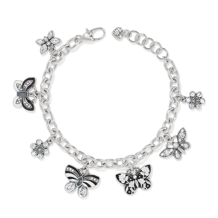 Brighton charm bracelet with silver-plated chain, enamel butterflies, and crystal flower charms on a white background