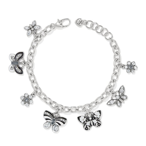 Brighton charm bracelet with silver-plated chain, enamel butterflies, and crystal flower charms on a white background