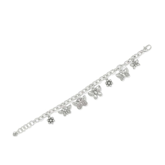 Brighton charm bracelet with silver-plated butterfly and flower charms featuring crystal accents on a white background