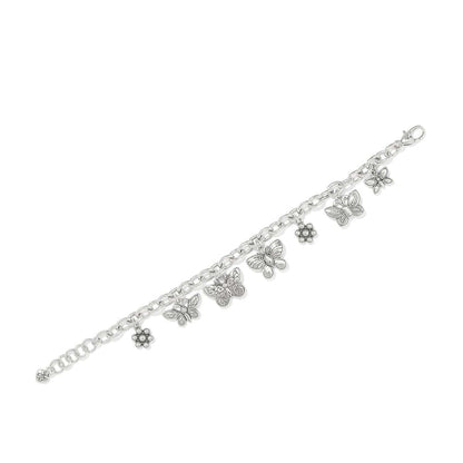 Brighton charm bracelet with silver-plated butterfly and flower charms featuring crystal accents on a white background