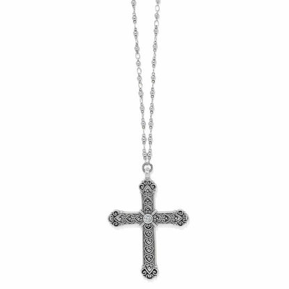 Brighton pendant necklace with silver-plated ornate cross, scroll detailing, central crystal, and beaded chain on a white background
