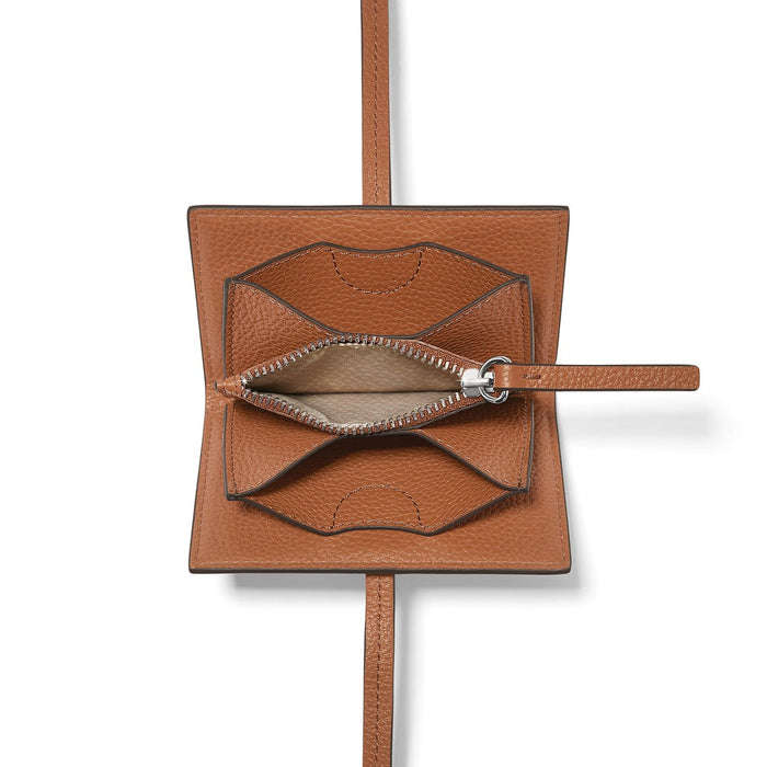 Brighton tan leather pouch shown open with silver-tone zipper, wrist strap, and long shoulder strap on a white background