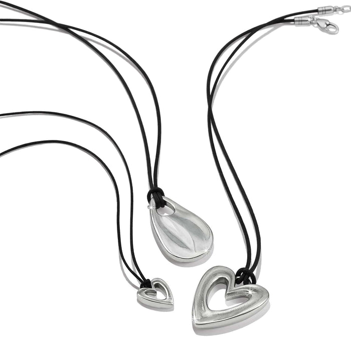 Brighton necklaces with silver-plated heart and teardrop pendants on black cords on a white background