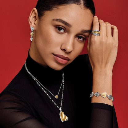 Model wearing Brighton two-tone heart drop earrings and pendant necklace with coordinating Brighton accessories