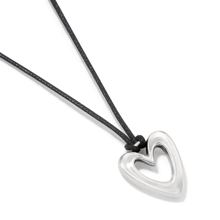 Brighton heart pendant necklace with silver-plated open heart charm and black cord on a white background