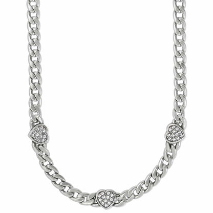 Brighton silver-plated curb chain necklace with three crystal-set heart stations on a white background