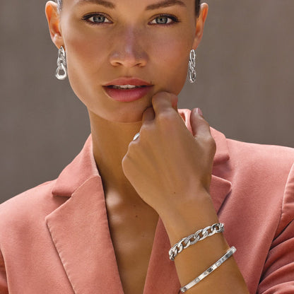 Model wearing Brighton silver-plated drop earrings with link design and coordinating Brighton bracelets with crystal accents