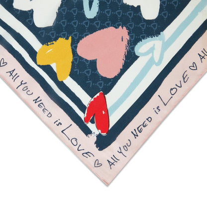 Close-up of Brighton scarf corner with navy heart print, colorful hearts, and All You Need is Love border