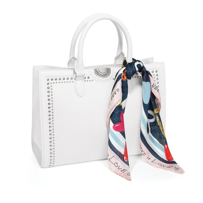 Brighton white leather handbag with silver-tone studs, dual handles, and printed scarf tied to side on a white background