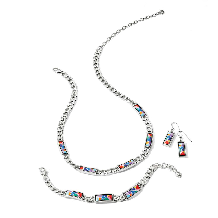 Brighton silver-plated necklace, bracelet, and earrings styled together with multicolor enamel mosaic panels on a white background
