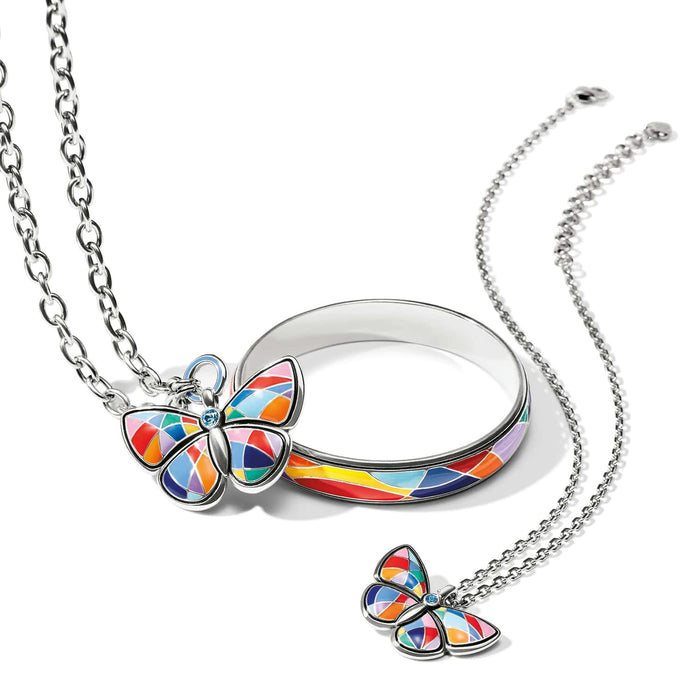 Brighton butterfly jewelry set with silver-plated bangle, necklace, and enamel butterfly charms in rainbow mosaic on white background