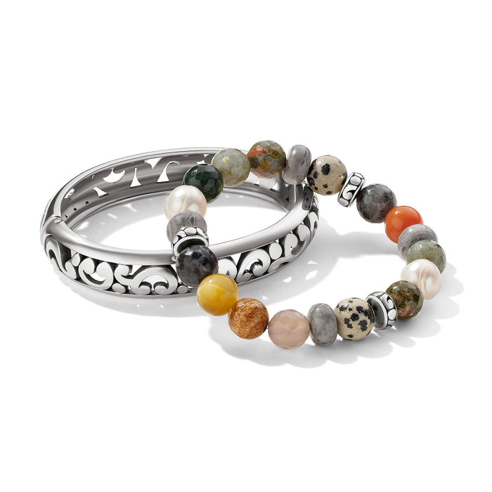 Brighton bangle bracelet with silver-plated scroll design and beaded stretch bracelet with multicolored gemstones on a white background