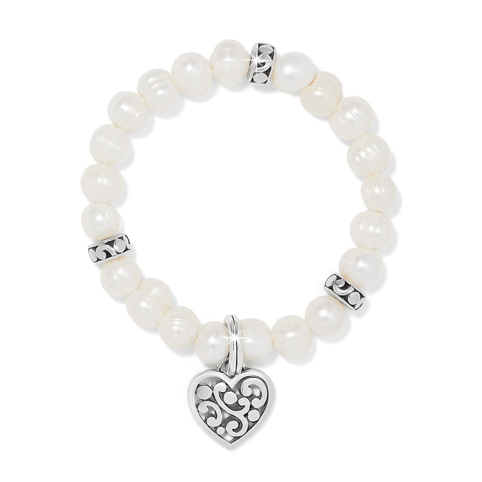 Brighton beaded bracelet with potato pearls, silver-plated scroll spacers, and heart charm pendant on a white background