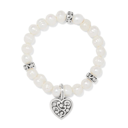 Brighton beaded bracelet with potato pearls, silver-plated scroll spacers, and heart charm pendant on a white background