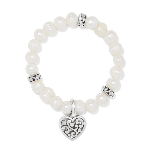 Brighton beaded bracelet with potato pearls, silver-plated scroll spacers, and heart charm pendant on a white background