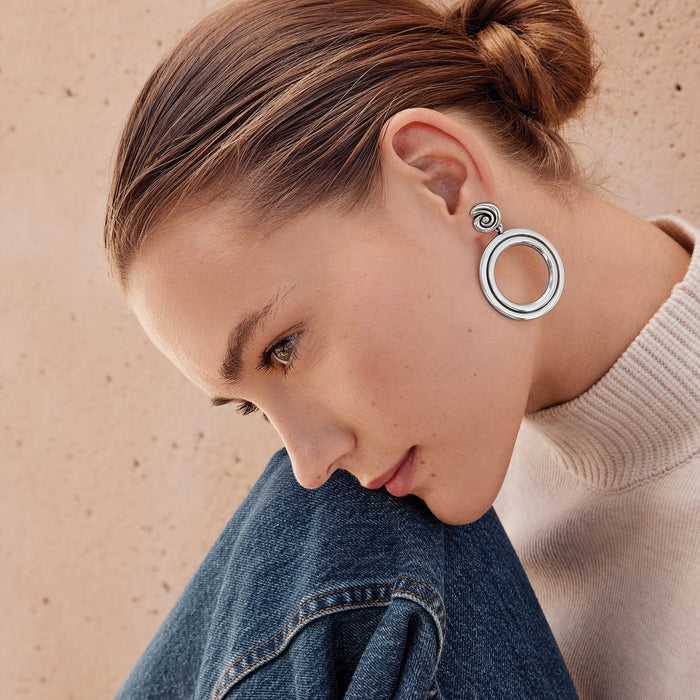 Model wearing Brighton silver-plated drop earrings with open circle design and spiral swirl post detail